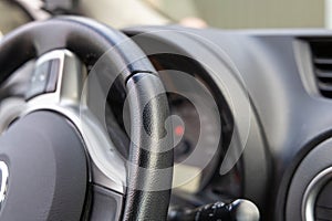 Black leather streering wheel and control panel in the car.