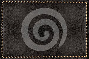 Black leather texture background with orange seams