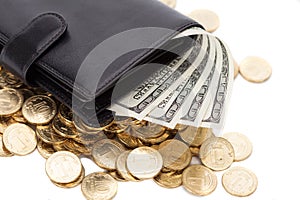 Black leather wallet with dollars and golden coins on white