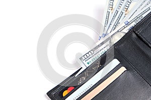 Black leather wallet with stack hundred dollar bills and bank cards on white background.Concept wealth and affluence