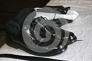 Black leather wingtip mens dress shoes with black socks and belt photo