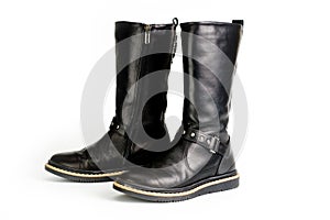 Black leather womenï¿½s boots fastened with a zipper. Background for shoes