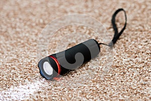 Black led flashlight with beam of light