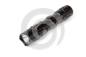 Black LED flashlight isolated on white.