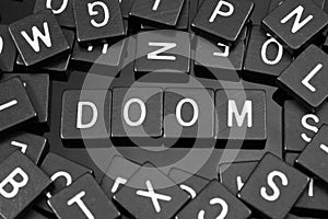 Black letter tiles spelling the word & x22;doom& x22;