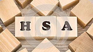 Black letters hsa on wooden cubes and numerous empty details