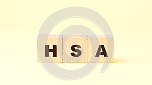 Black letters hsa written on small wooden blocks on yellow