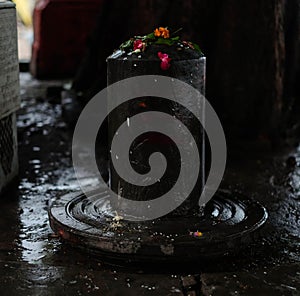 Black Lingam with black background.