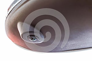 Black lower part of the rearview mirror with a circular camera. Left side view fisheye camera of a car