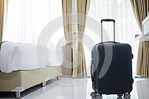 Black Luggage in modern hotel room with windows, curtains and bed background. Time to travel, relaxation, journey, trip and