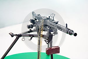 Black machine gun with chain of cartridges
