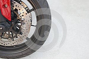 Black magnesium alloy wheel of red motorcycle and disc brake