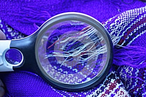 black magnifying glass magnifying colored threads