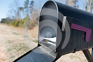 Black mail box and post office mail with blue sky