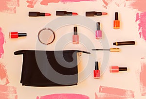 Black makeup bag with lipsticks, nail polishes, face powder and mascara