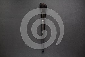 Black makeup brush on black background