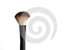 Black makeup brush on a white background.