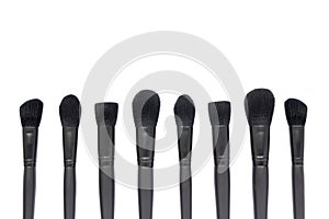 Black makeup brushes isolated on white background