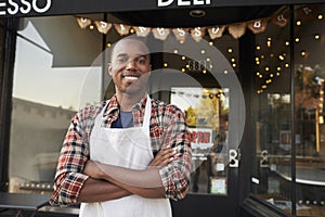 Black male business owner standing outside coffee shop