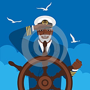 Black male captain looks into distance standing at helm of boat
