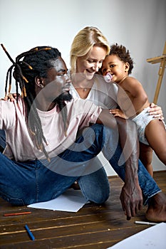 Black male and caucasian female with dark skinned child daughters in diapers