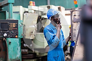 Black Male Engineer Working on machine in Factory. black man engineer checking Quality control the condition of the machine.