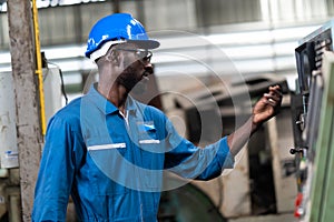 Black Male Engineer Working on machine in Factory. black man engineer checking Quality control the condition of the machine.