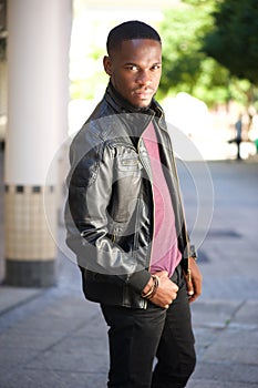 Black male fashion model posing in leather jacket