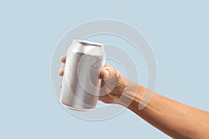 Black male hand holding aluminum can on cyan background