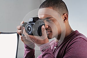 Black male photographer focusing on his subject