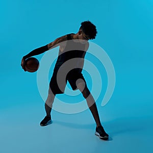 Black male player dribbling with basketball ball