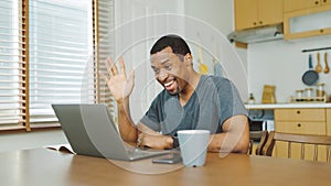 Black male waving hand while having video call