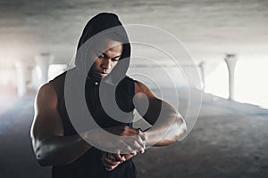 Black man, athlete and smart watch for running monitor in parking garage for heart rate, calories or cardio. Male person