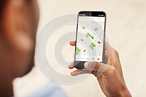 Black Man Booking Taxi Via Phone Using Application Indoors, Cropped