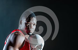 Black man boxing in studio