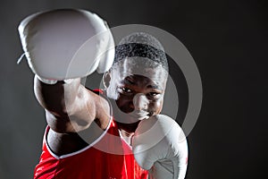 Black man boxing in studio