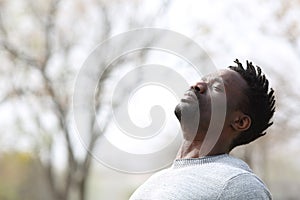 Black man breathing fresh air outdoors in winter