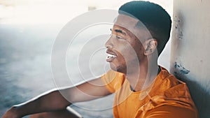 Black man, breathing and recover after exercise, relax with smile for wellness and health outdoor. Athlete on break from
