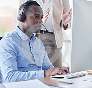 Black man, call center and coach by computer for training in telemarketing, customer service or support at office