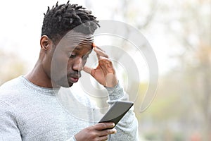 Black man complaining making mistake on smart phone