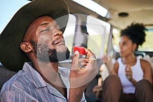 Black man, eating watermelon and summer fruit on safari game drive in sustainability nature or environment landscape