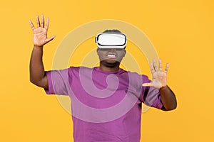 black man engrossed in simulation game via VR headset, studio