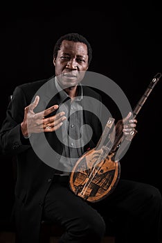 Black man with ethnic musical instrument