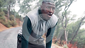 Black man, forest and tired with jog for fitness with cardio and hands on knees in California. Workout, exercise and