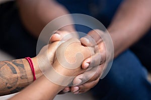 Black man friend holding hands of african woman, closeup view