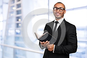 Black man holding a book