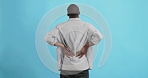 Black man holding his hands behind his back, stretching spine