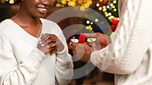 Black man making proposal to his girlfriend on Christmas