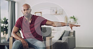 Black man, microphone and portrait in chair, living room and speech for speaking, home and drop mic. Confident, speaker