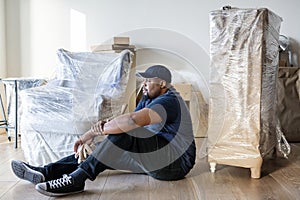 A black man moving furniture